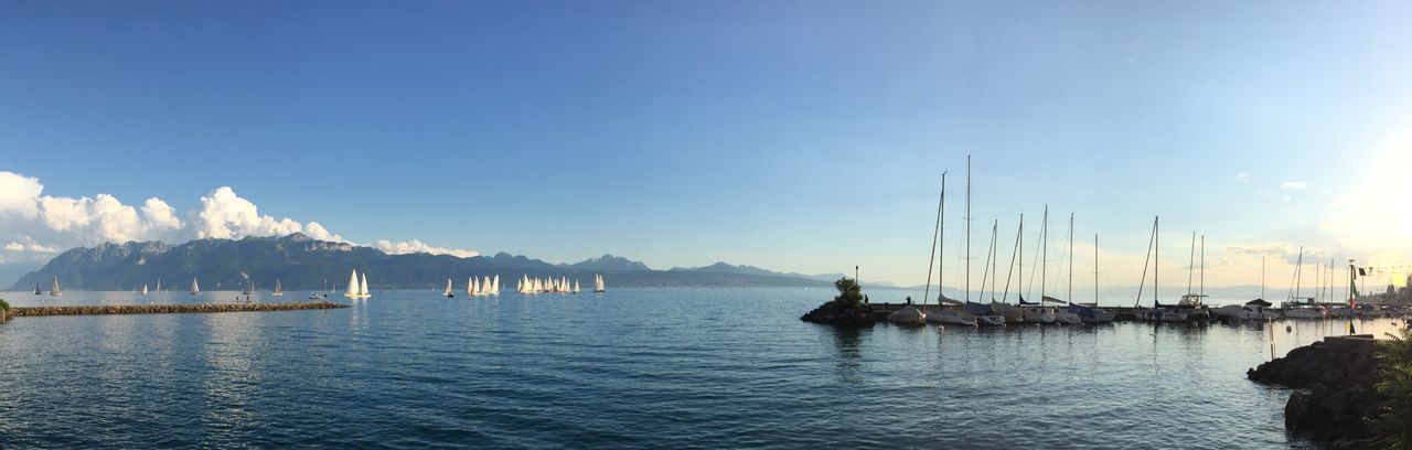 Panoramic view of boats on lake geneva against sky