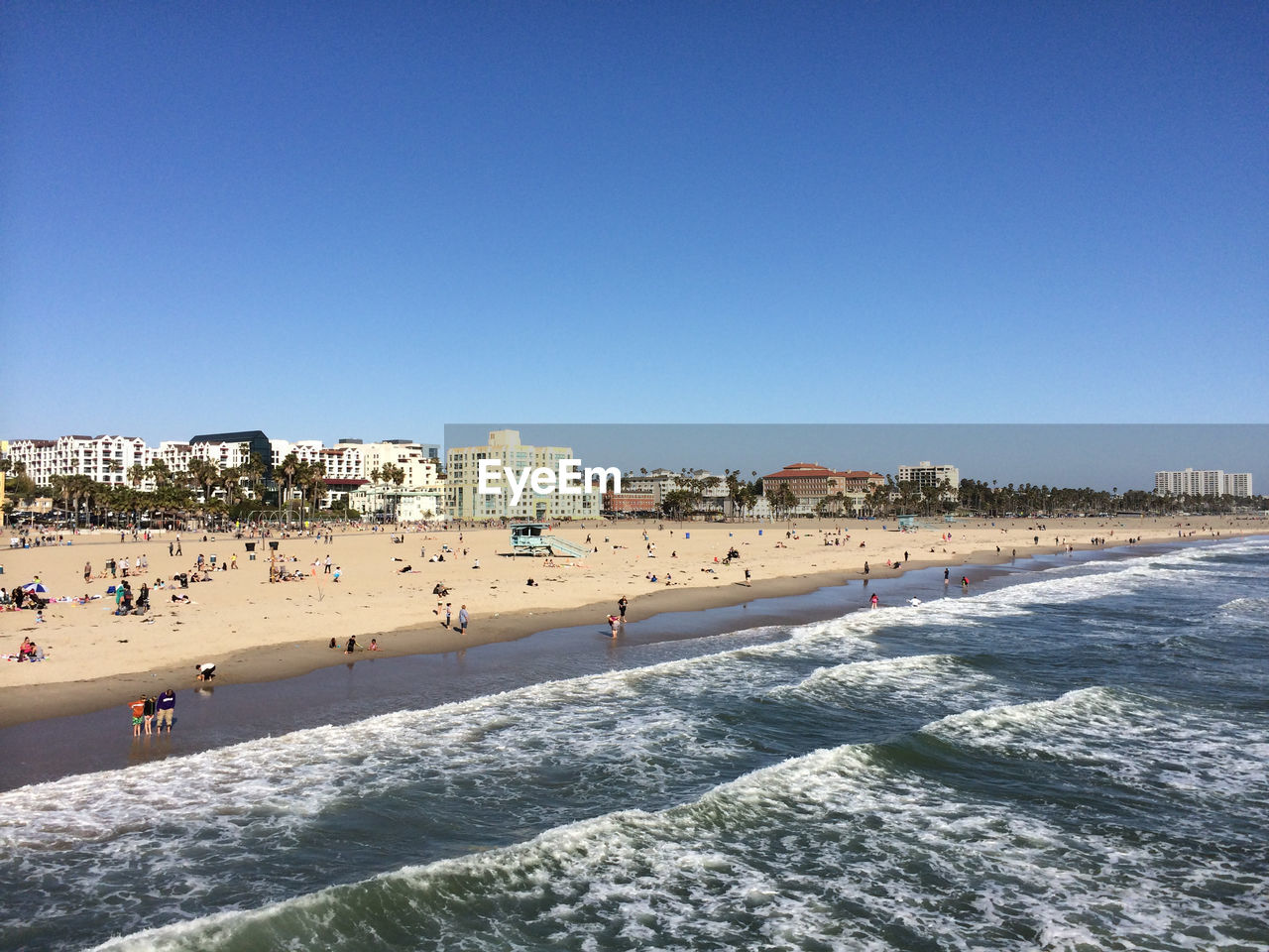 View of beach against clear blue sky