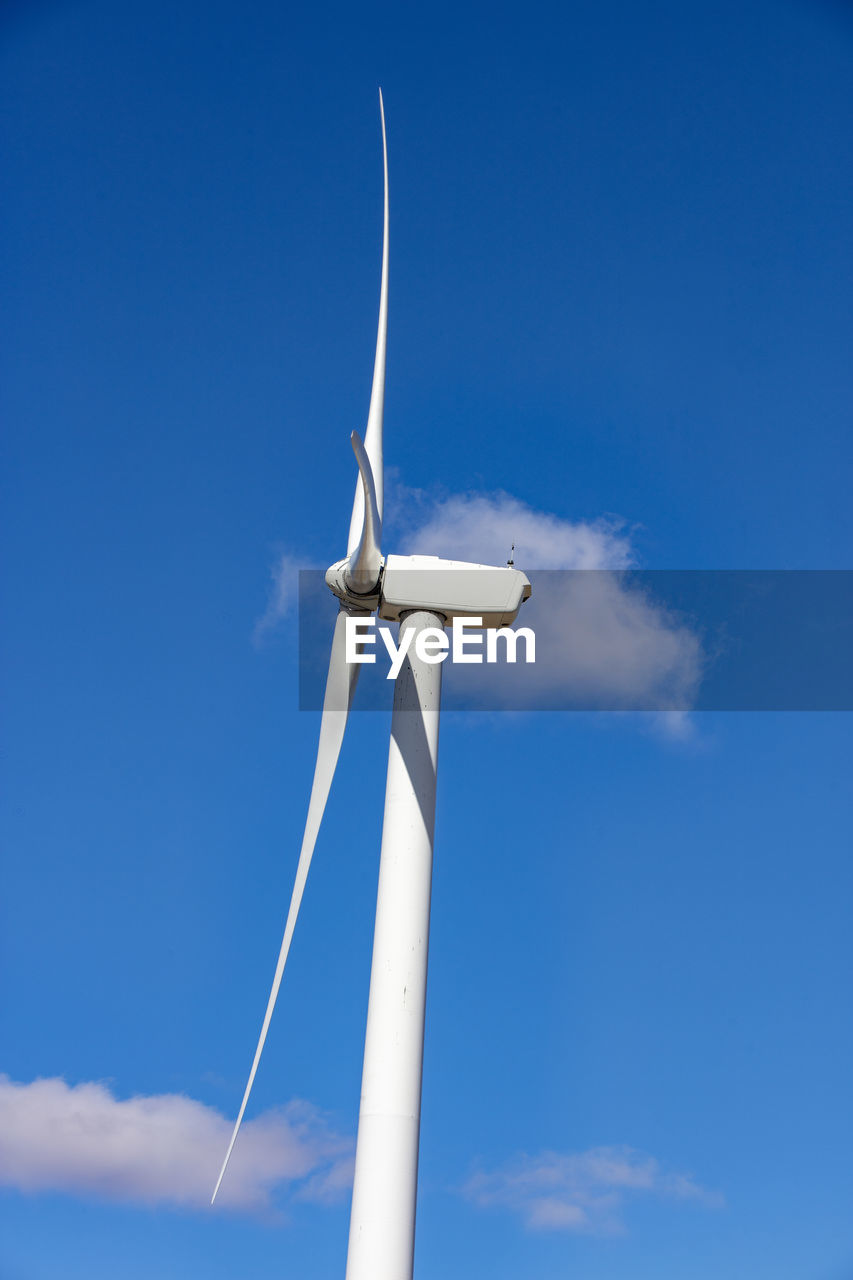 Wind turbine with blue sky and clouds
