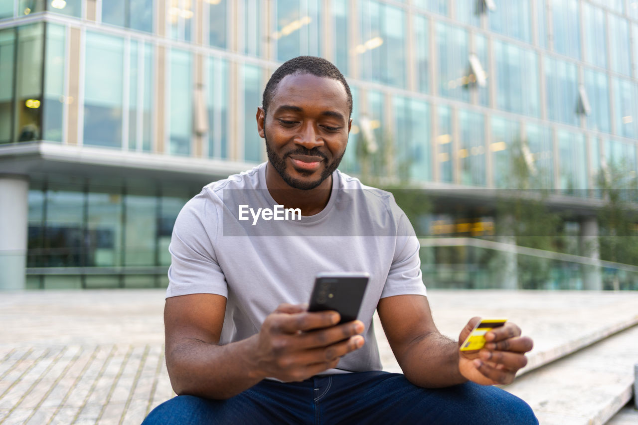 portrait of young man using mobile phone