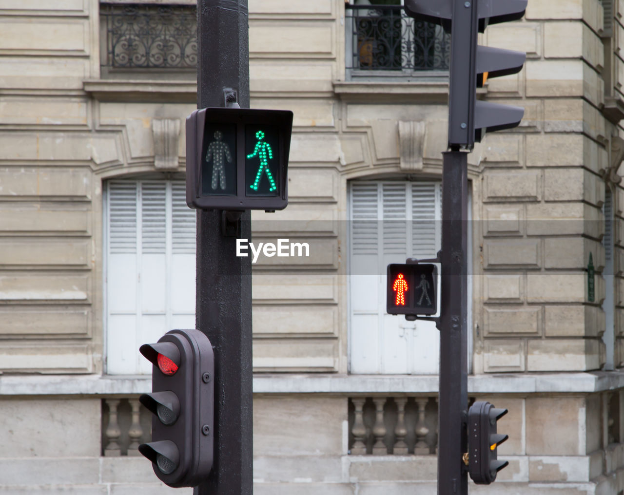 Close-up of traffic signals against the wall