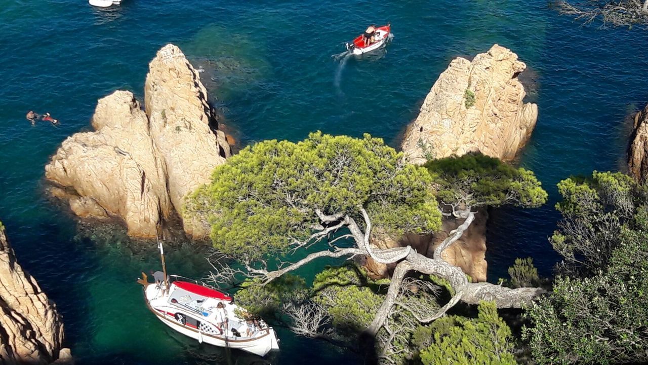 High angle view of boats and rock formations in sea