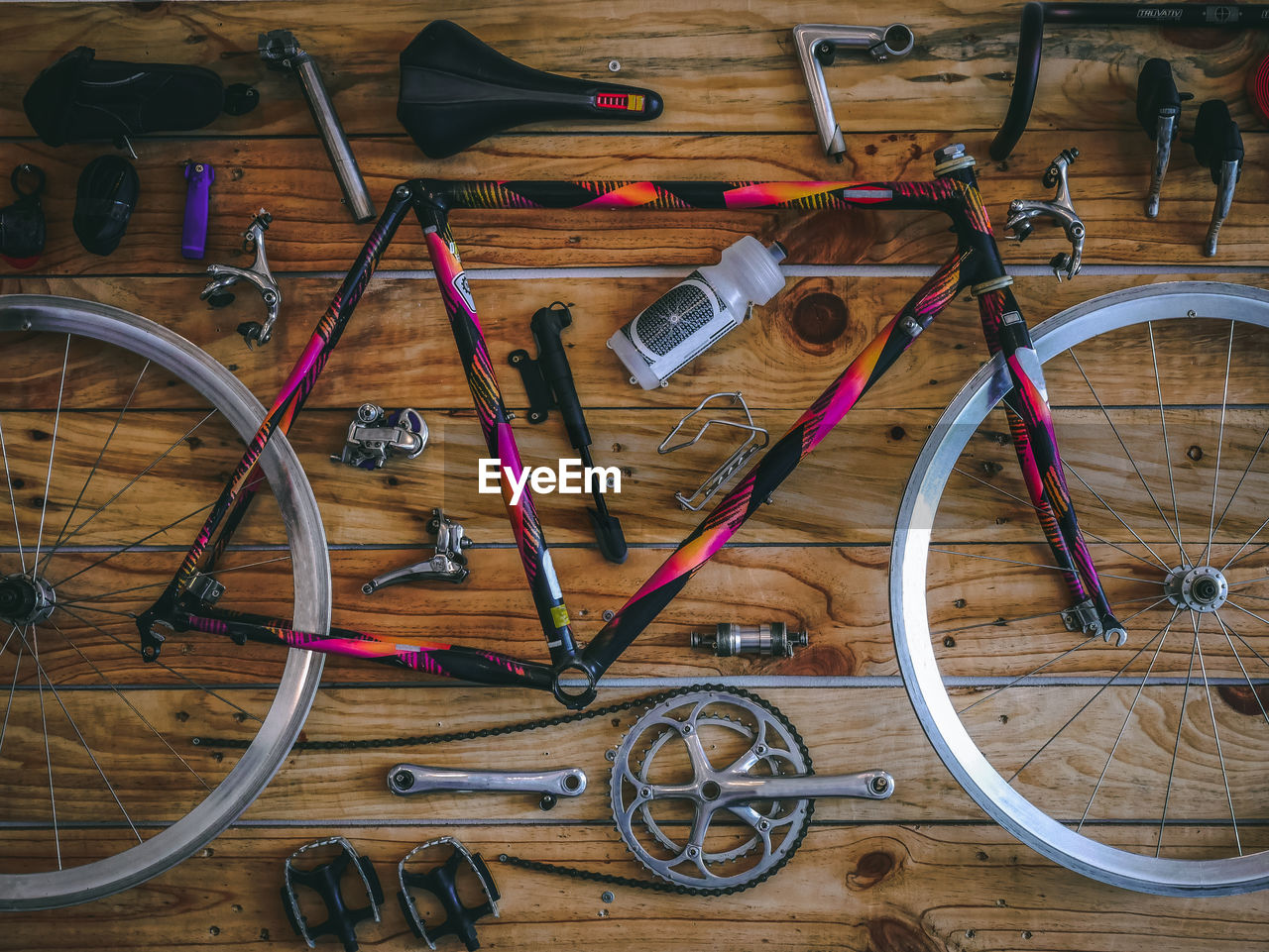 High angle view of bicycle parts on hardwood floor