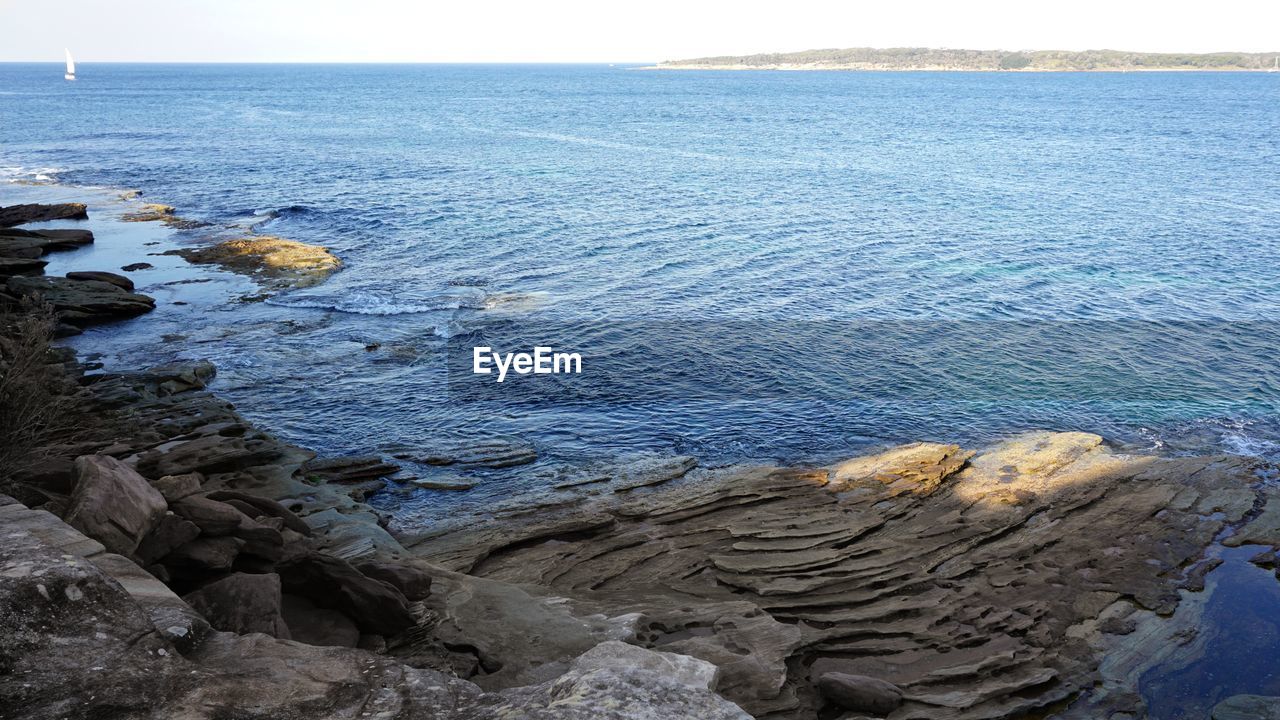 HIGH ANGLE VIEW OF ROCKS ON BEACH