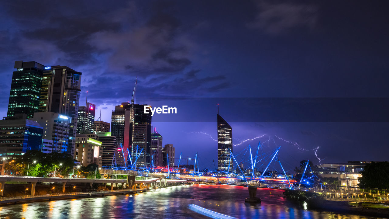 ILLUMINATED BUILDINGS AT WATERFRONT