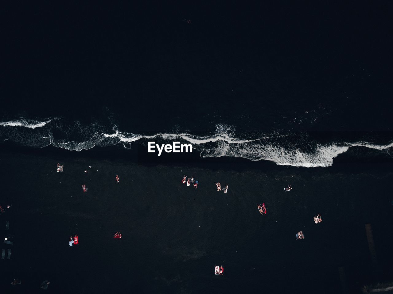 Aerial view of people at beach during night