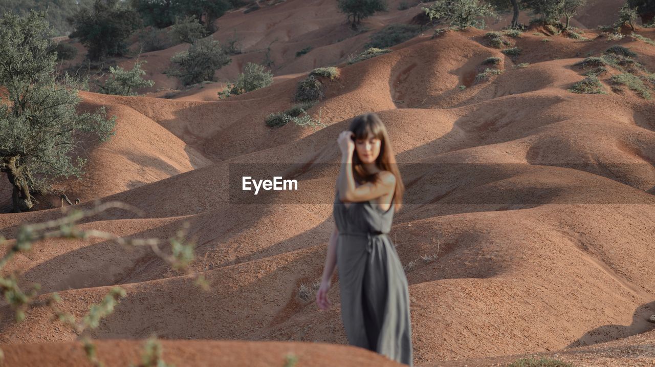 Defocused image of woman standing in desert