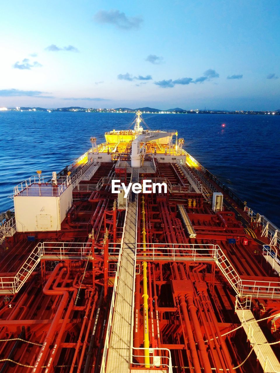 Aerial view of a vessel navigating against cloudy sky