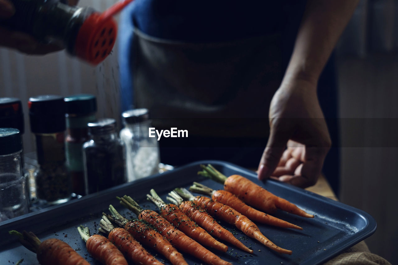 Midsection of woman preparing food on table