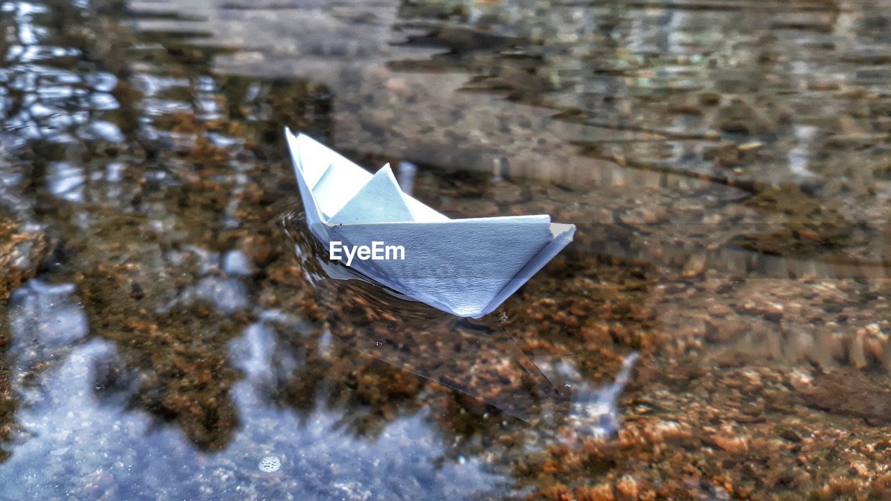 High angle view of paper floating on water