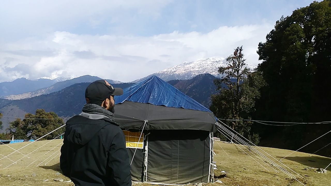 MAN ON MOUNTAIN ROAD AGAINST SKY