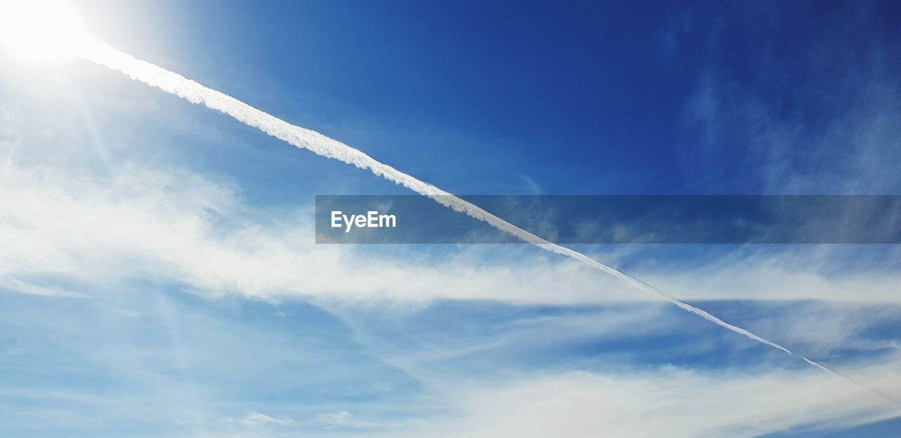 Low angle view of vapor trails in sky