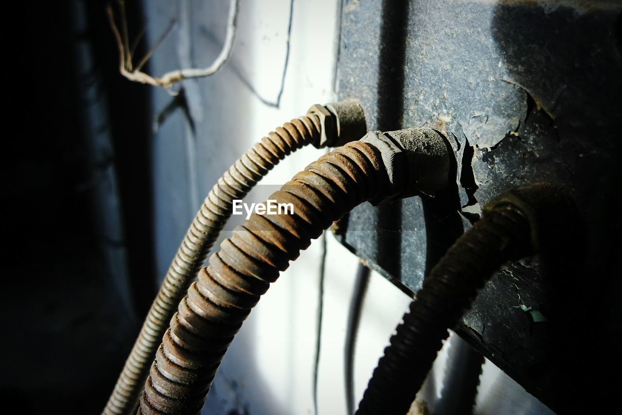 Close-up of wires on rusty metal in abandoned building