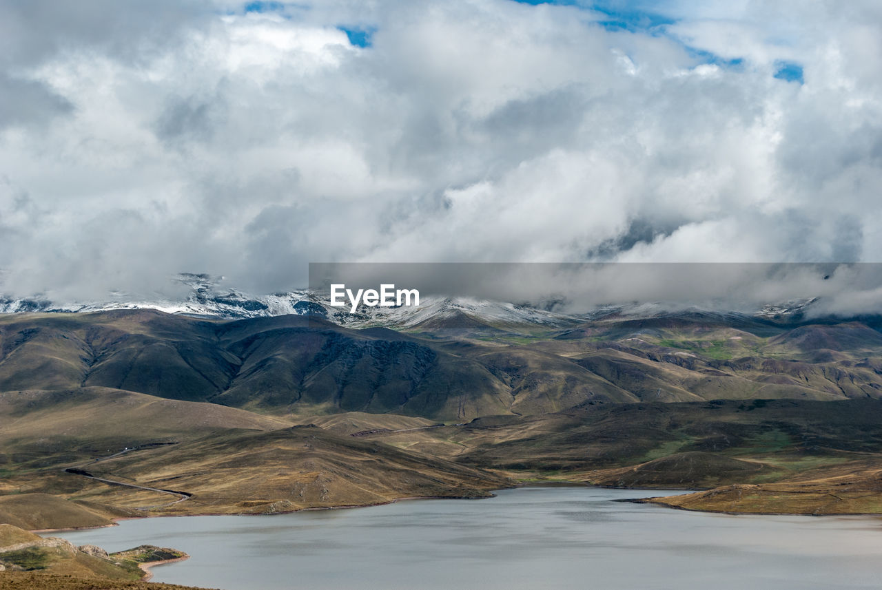 Scenic view of lake and mountains against sky