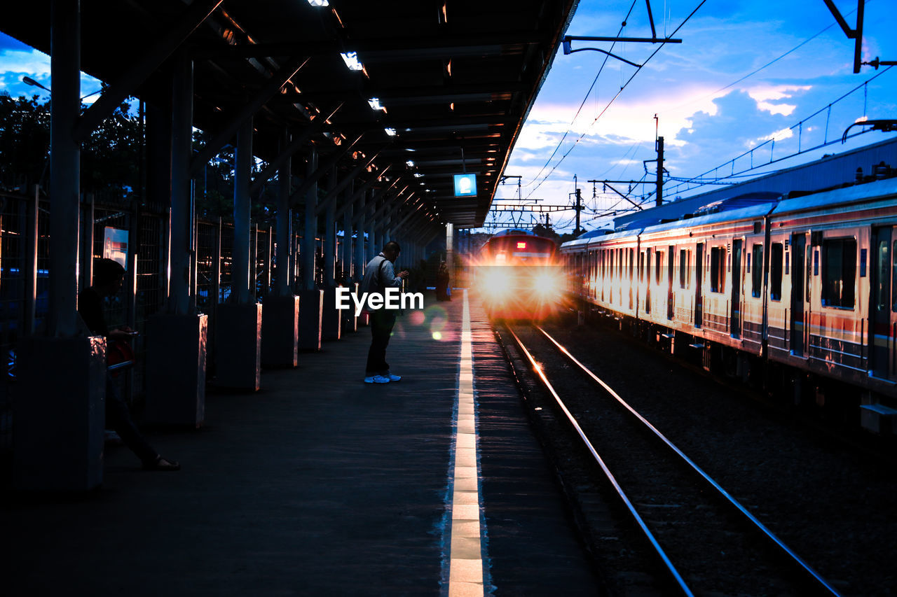 Landscape view of the train arrival at sunset