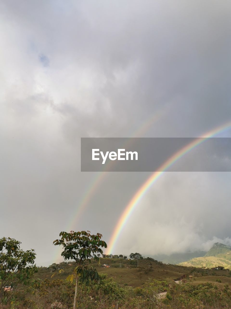 SCENIC VIEW OF RAINBOW OVER LAND AGAINST SKY