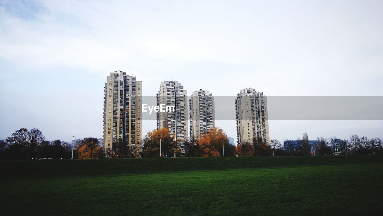 VIEW OF SKYSCRAPERS IN FIELD