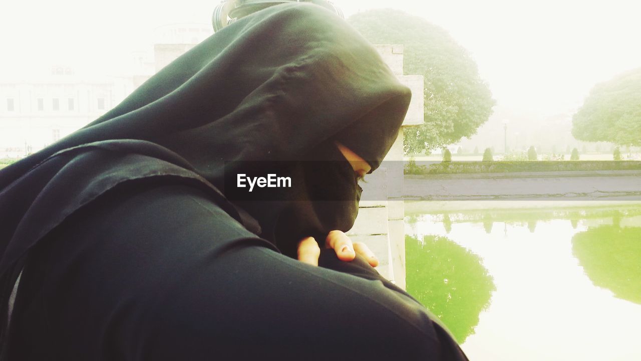 Woman wearing burka by lake