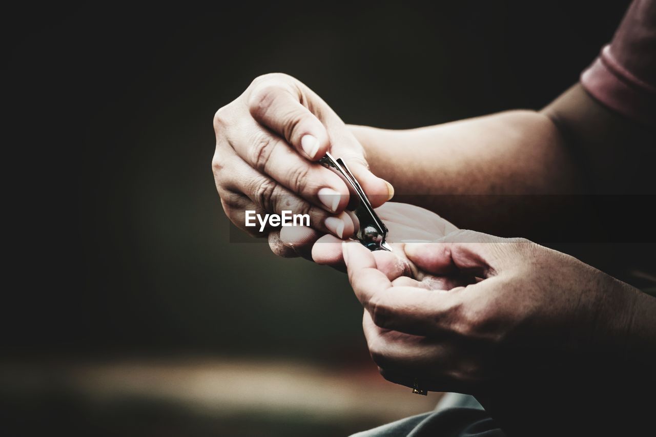 Close-up of hand holding nail clipper