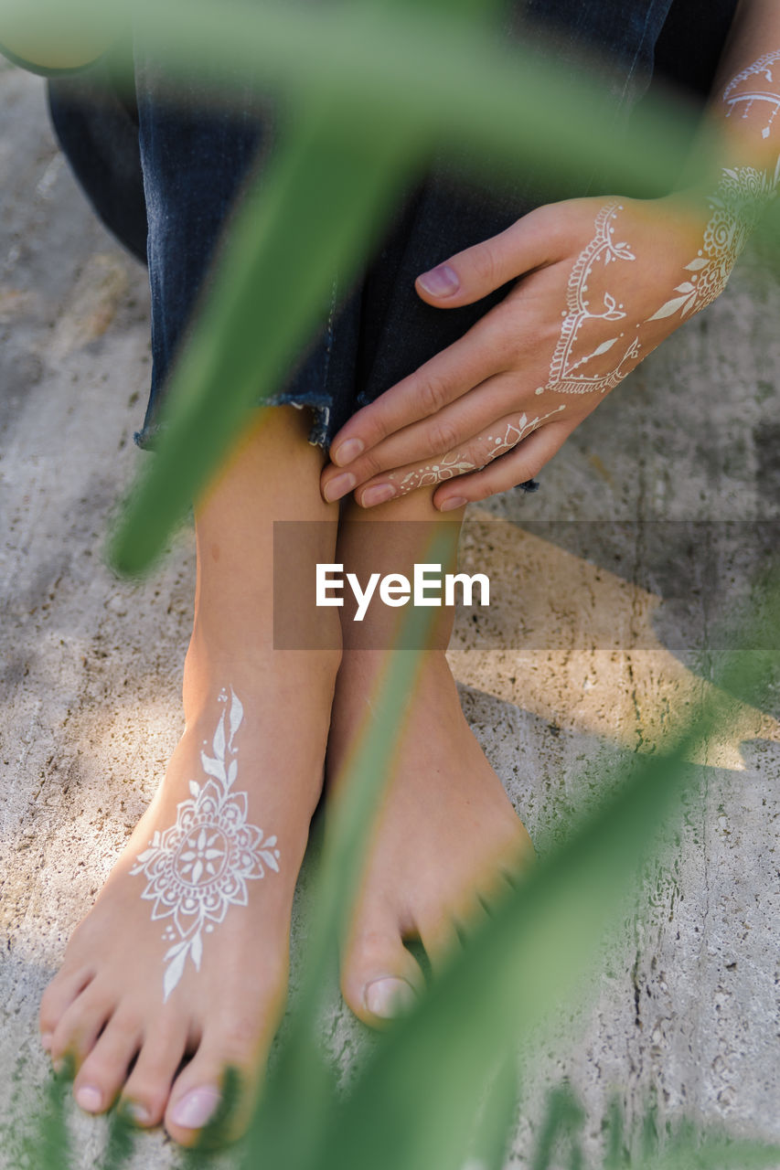 Low section of woman with henna tattoo