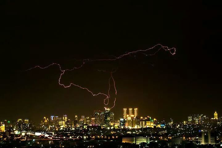 VIEW OF ILLUMINATED CITYSCAPE AT NIGHT