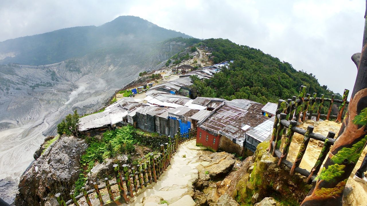 High angle view of buildings and mountains against sky