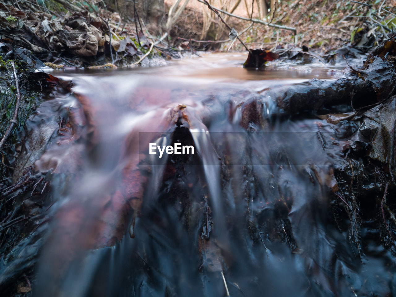 HIGH ANGLE VIEW OF STREAM FLOWING THROUGH ROCKS