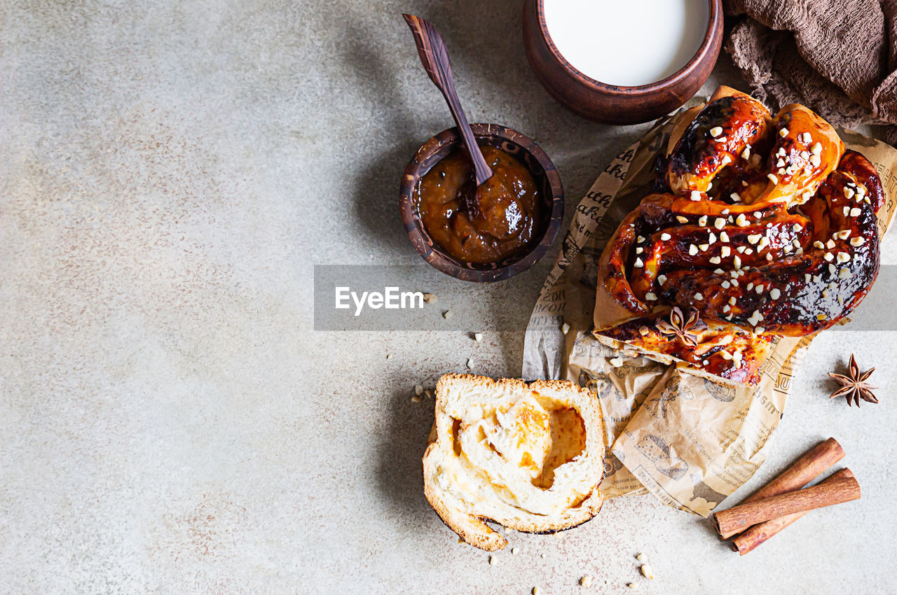 Apricot jam twisted loaf bread or babka with nuts and spices with a cup of milk. 