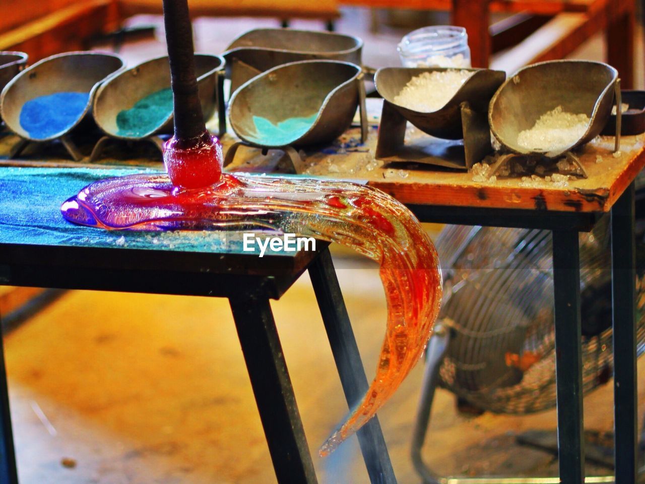 Close-up of melted glass on table