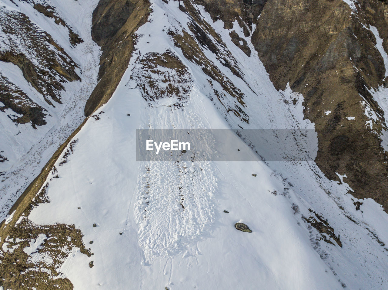 High angle view of snow covered mountain with avalanche in spring 
