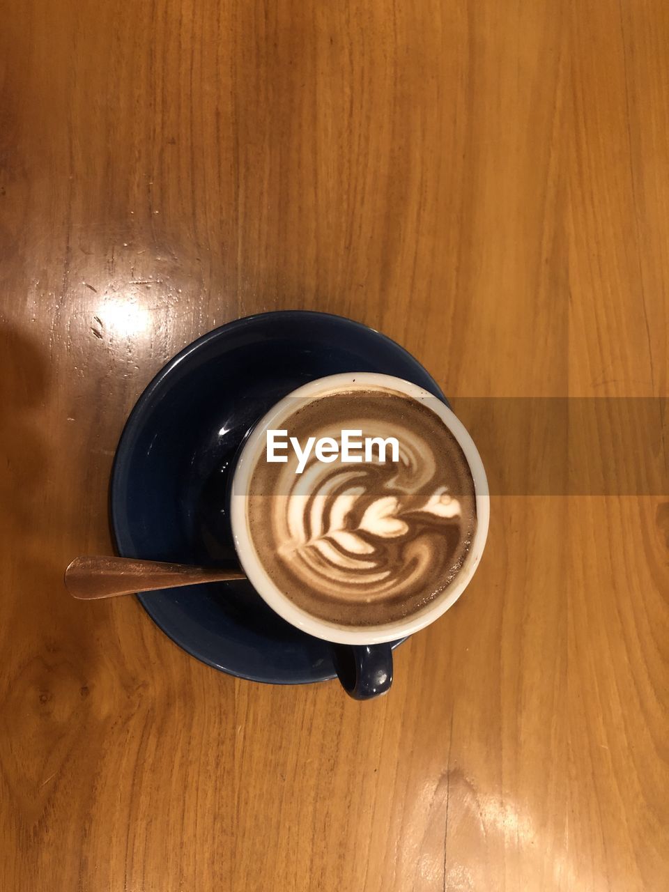 coffee, drink, food and drink, coffee cup, refreshment, cup, mug, frothy drink, cappuccino, table, wood, froth art, hot drink, still life, saucer, latte, crockery, indoors, high angle view, no people, freshness, kitchen utensil, food, directly above, spoon, close-up, brown, cafe, creativity