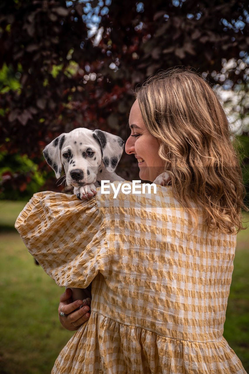 Young woman with a dalmatian puppy