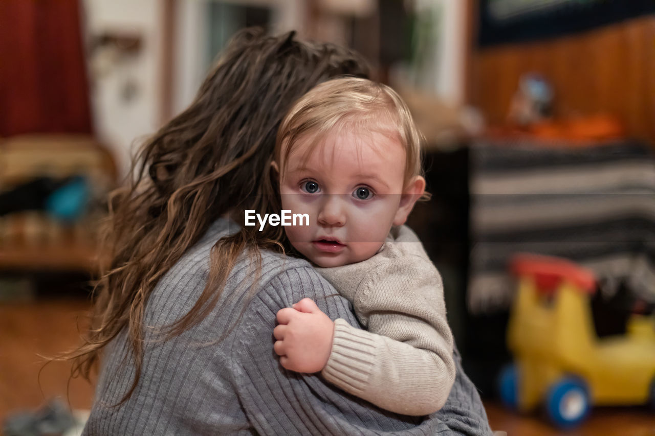 Portrait of cute baby girl with mother