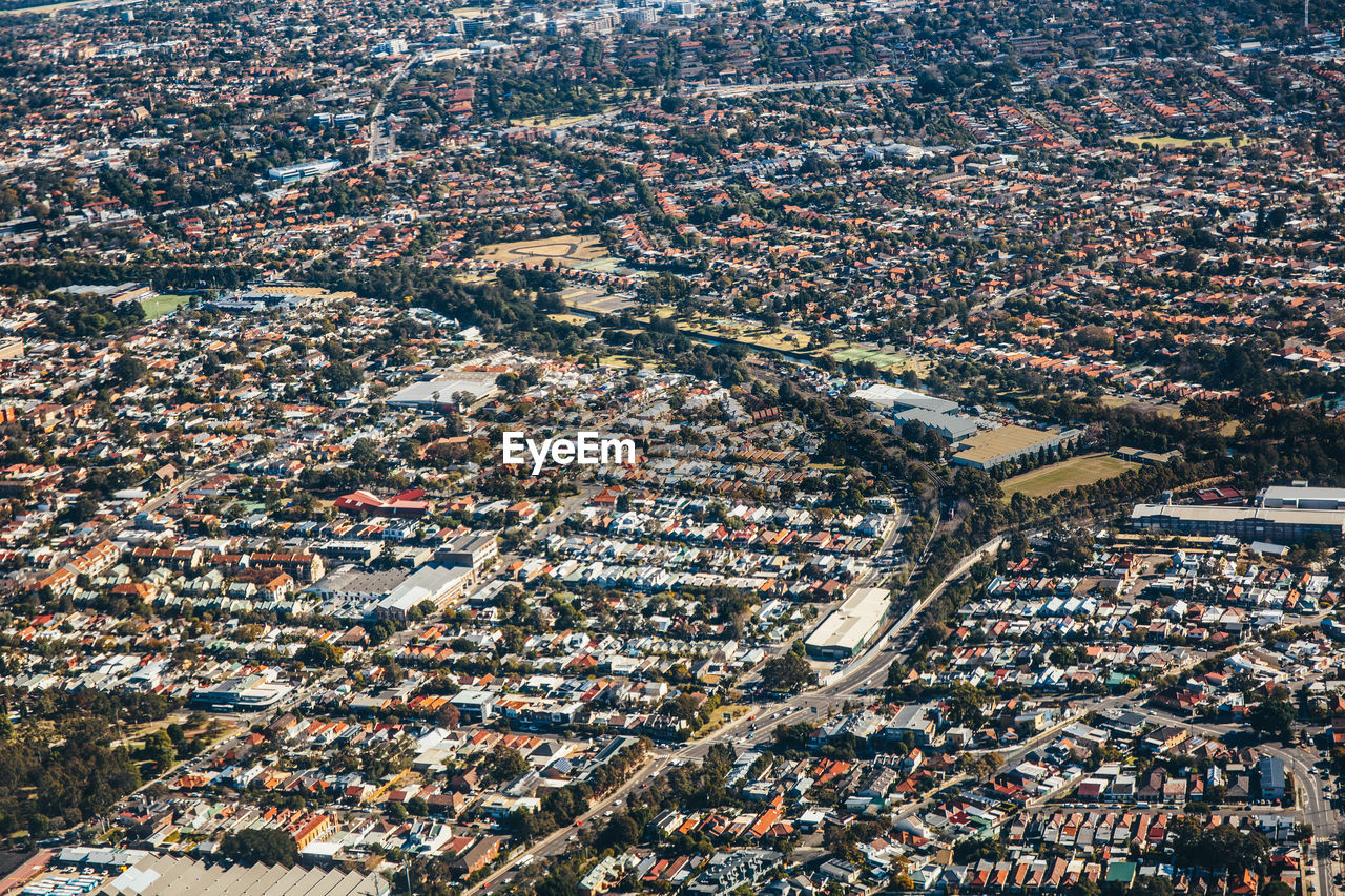 High angle view of street amidst houses in city