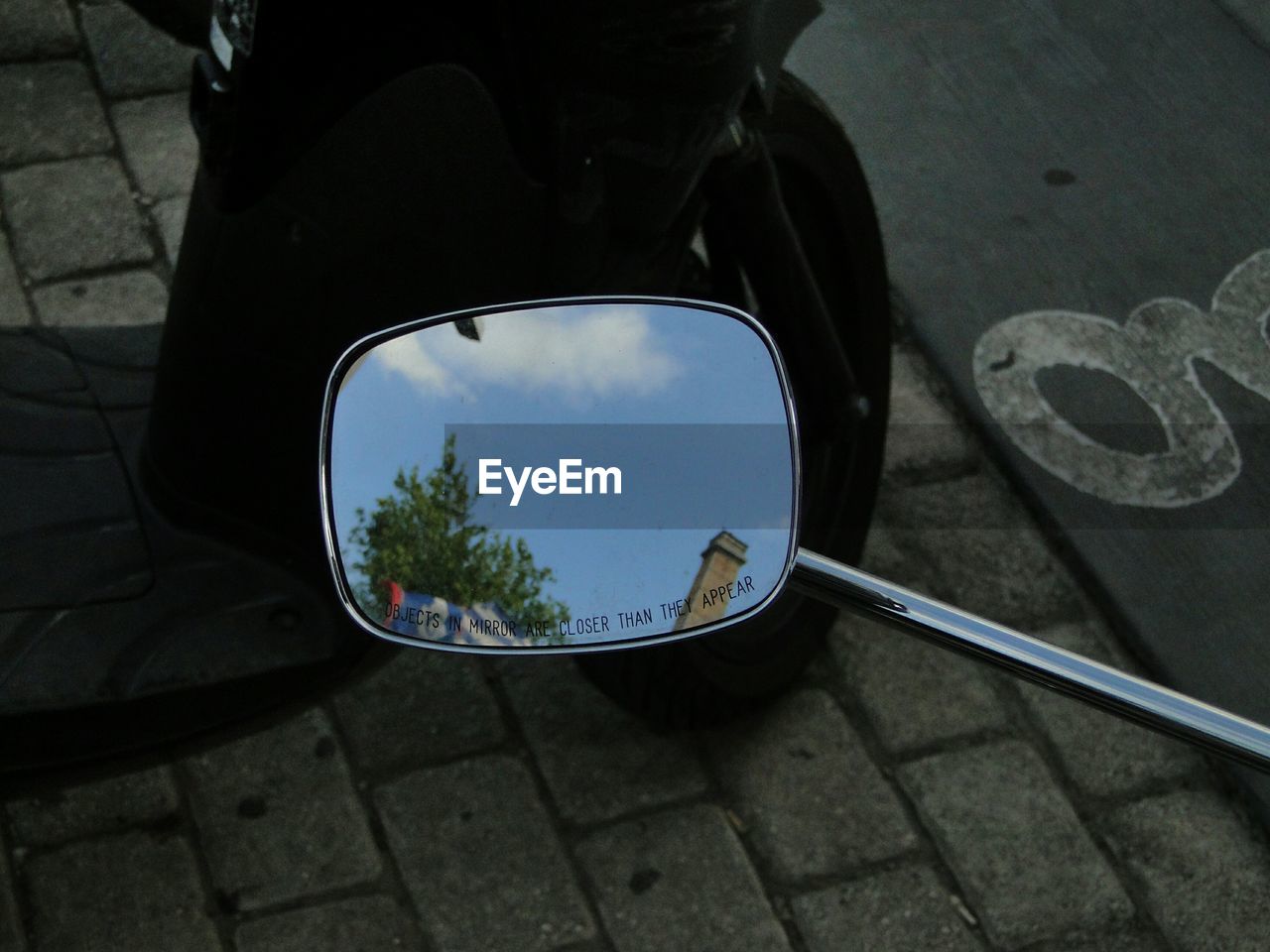 Reflection of tower on motorcycle mirror