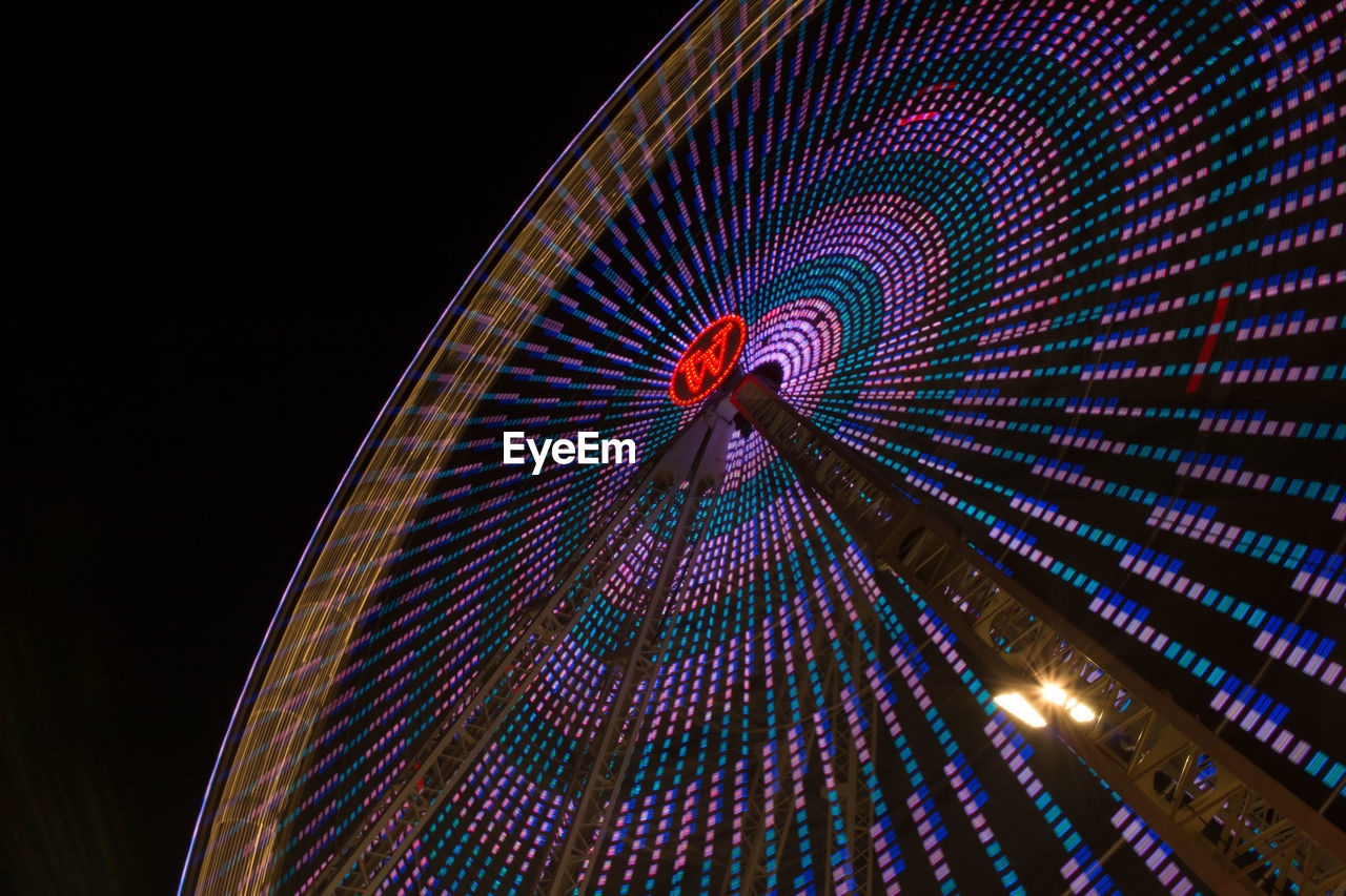 LOW ANGLE VIEW OF ILLUMINATED FERRIS WHEEL