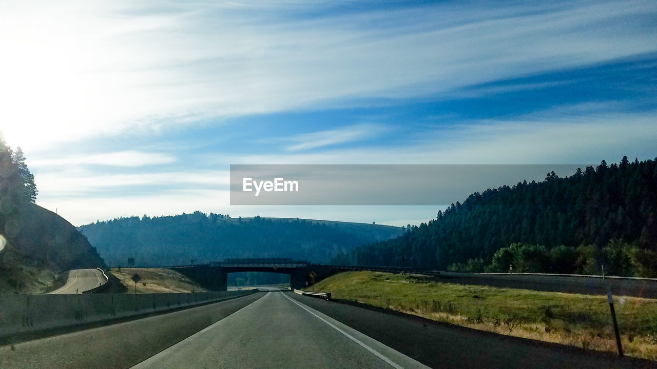 ROAD AMIDST MOUNTAINS AGAINST SKY