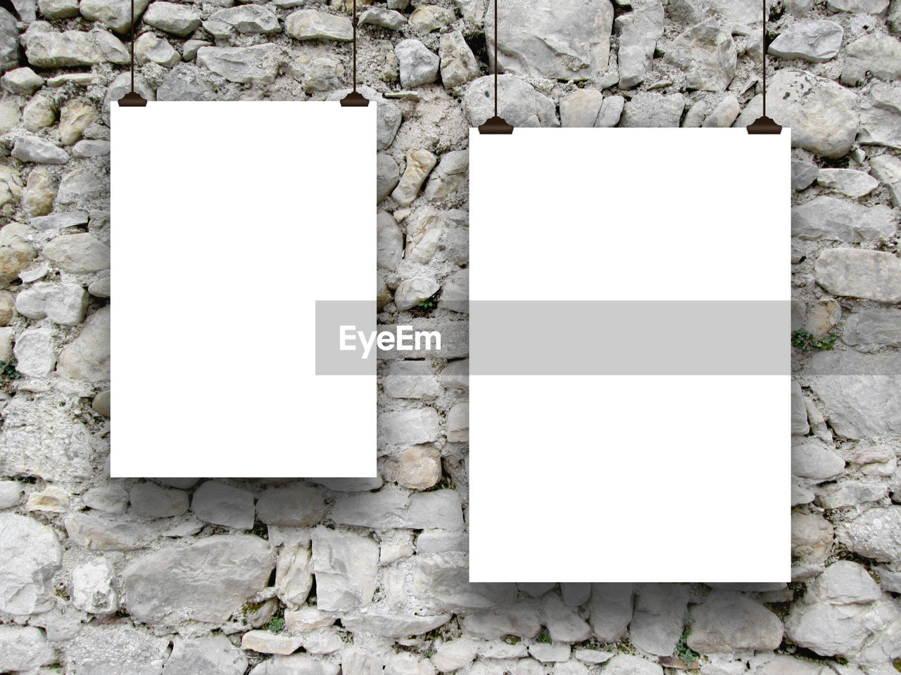Close-up of papers hanging on stone wall