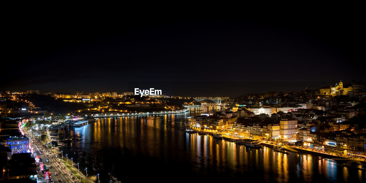 Illuminated cityscape against sky at night