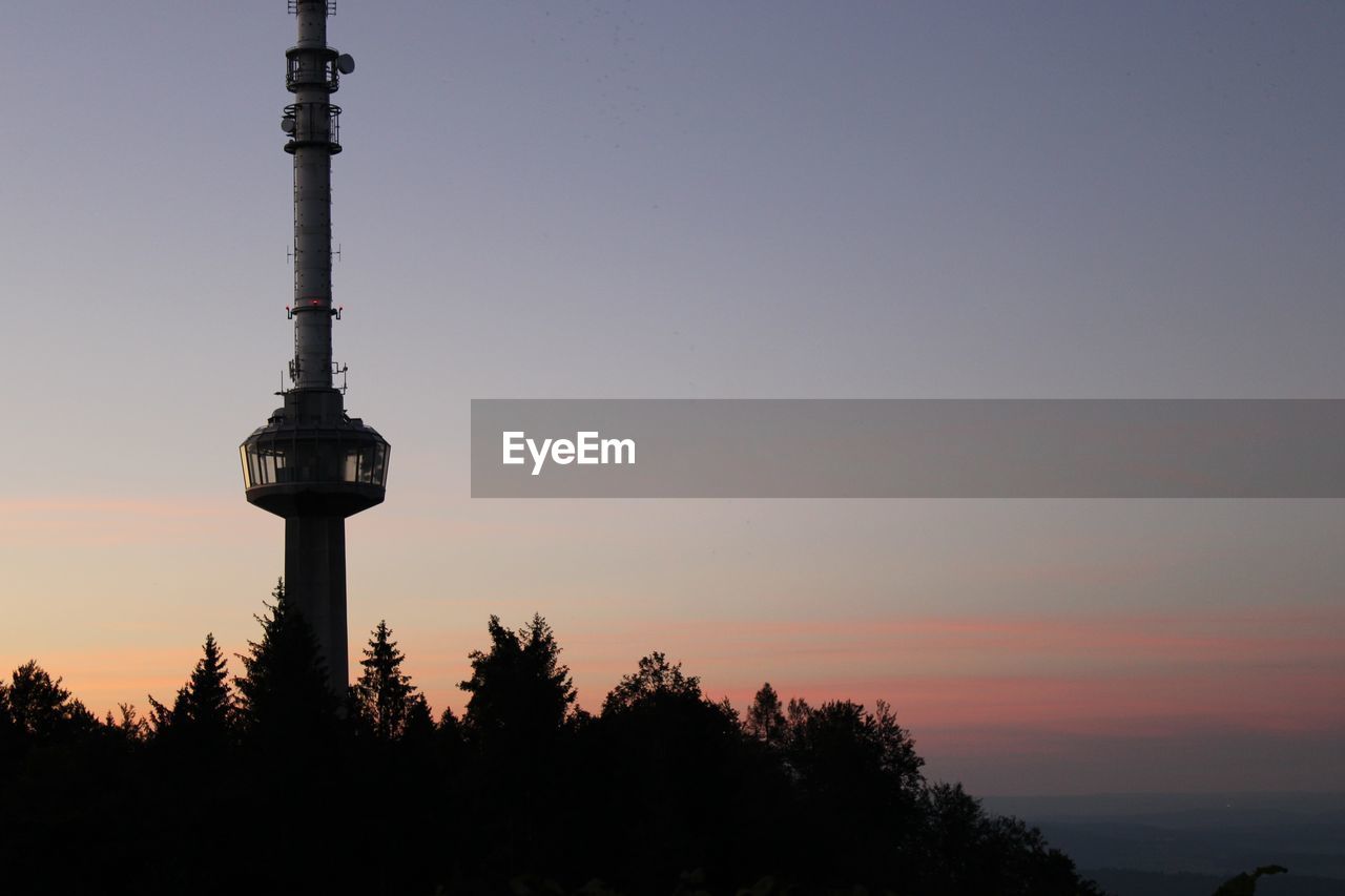 SILHOUETTE OF COMMUNICATIONS TOWER AT SUNSET