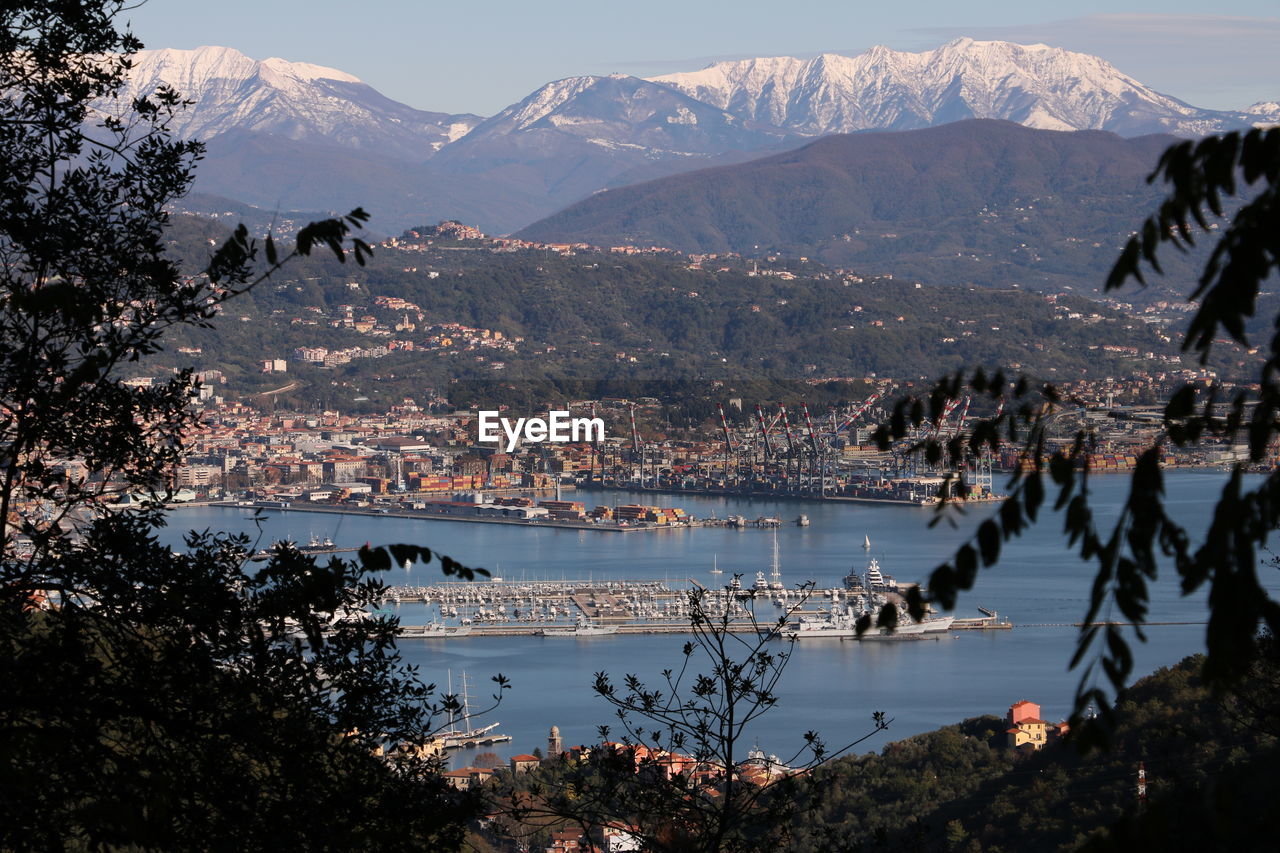 SCENIC VIEW OF CITY BY MOUNTAINS DURING WINTER