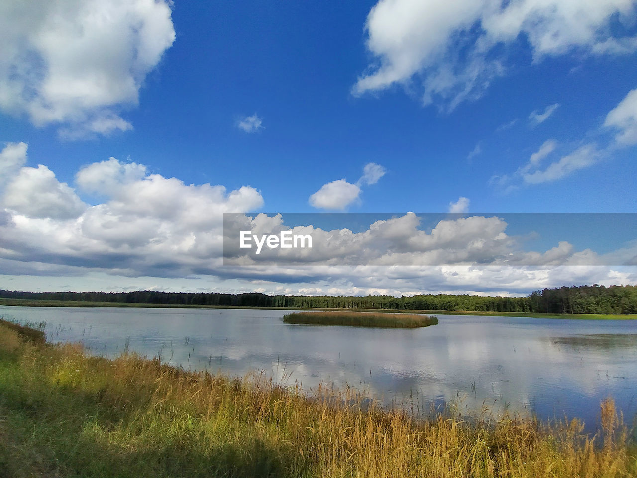 Scenic view of lake against sky, fish pond under blue sky