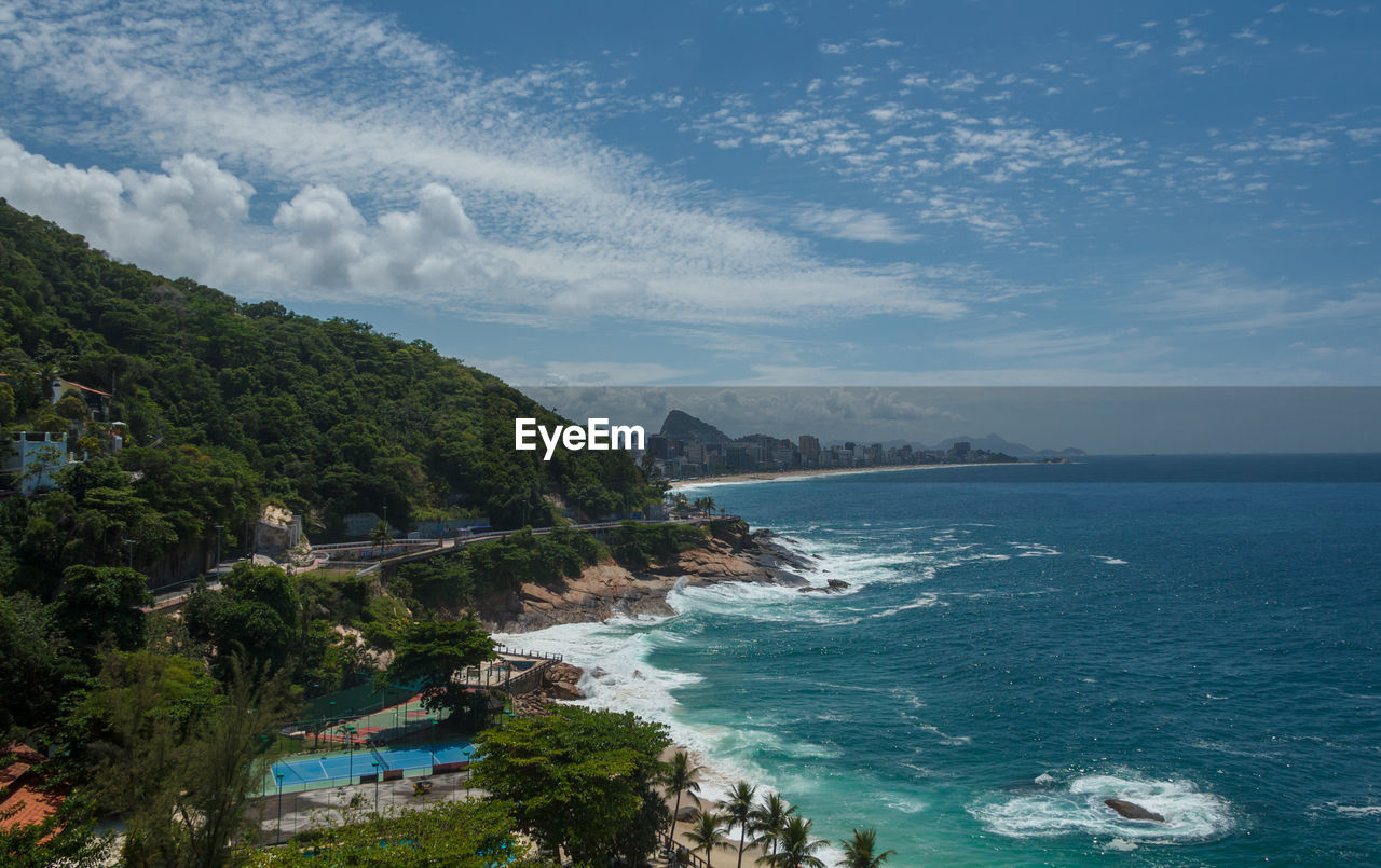 SCENIC VIEW OF SEA BY TREES AGAINST SKY