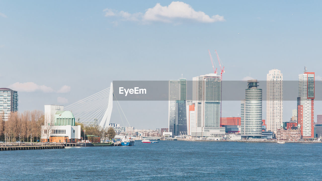 SEA BY BUILDINGS AGAINST SKY