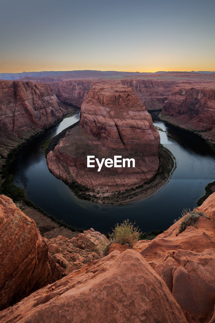 High angle view of horseshoe bend against sky during sunset