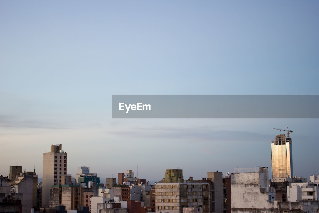 Buildings in city against sky