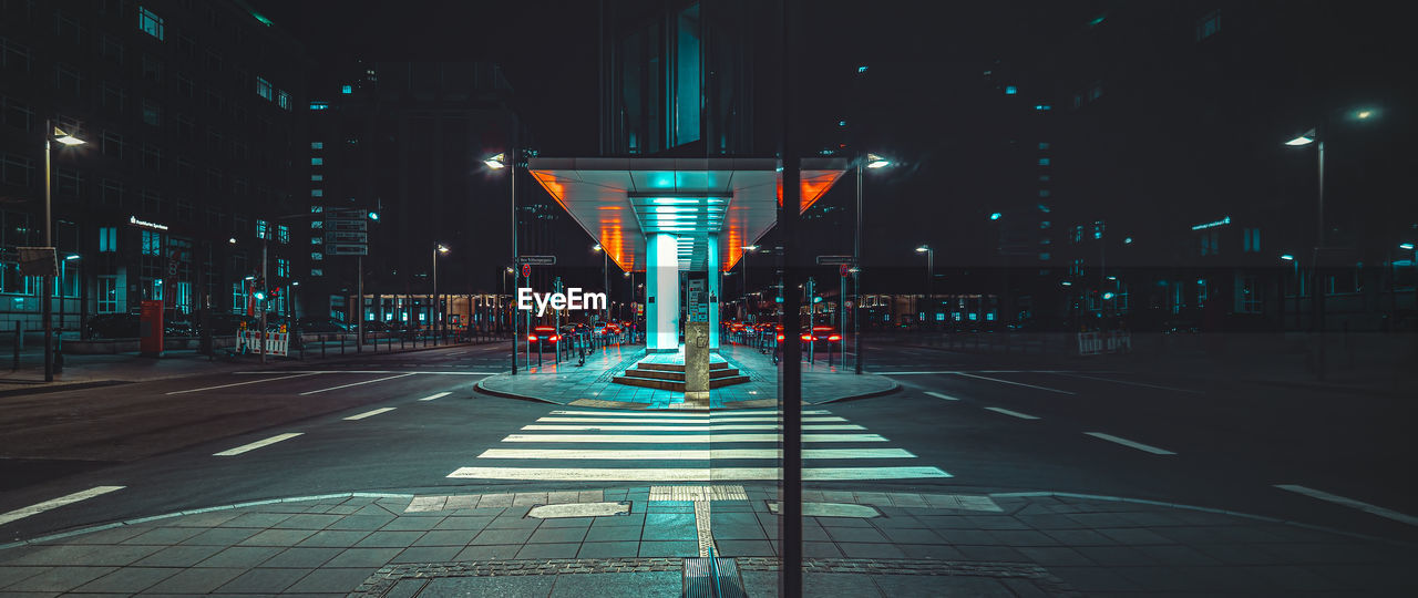 rear view of woman walking on street at night