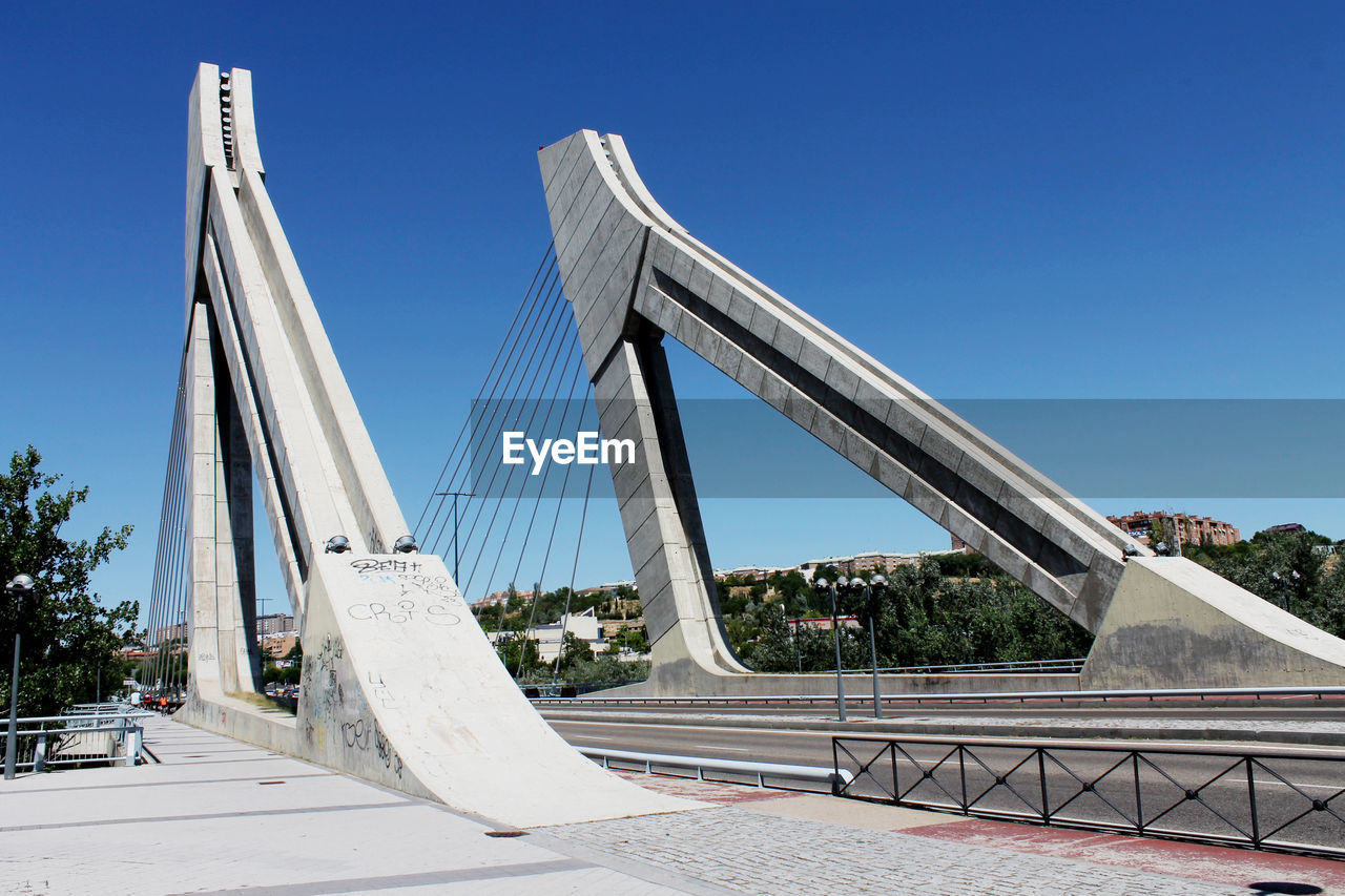 VIEW OF BRIDGE AGAINST BLUE SKY