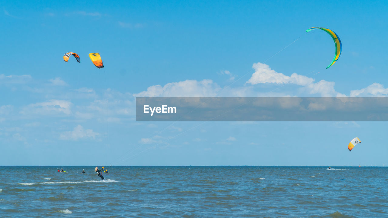 Kite flying over sea against sky