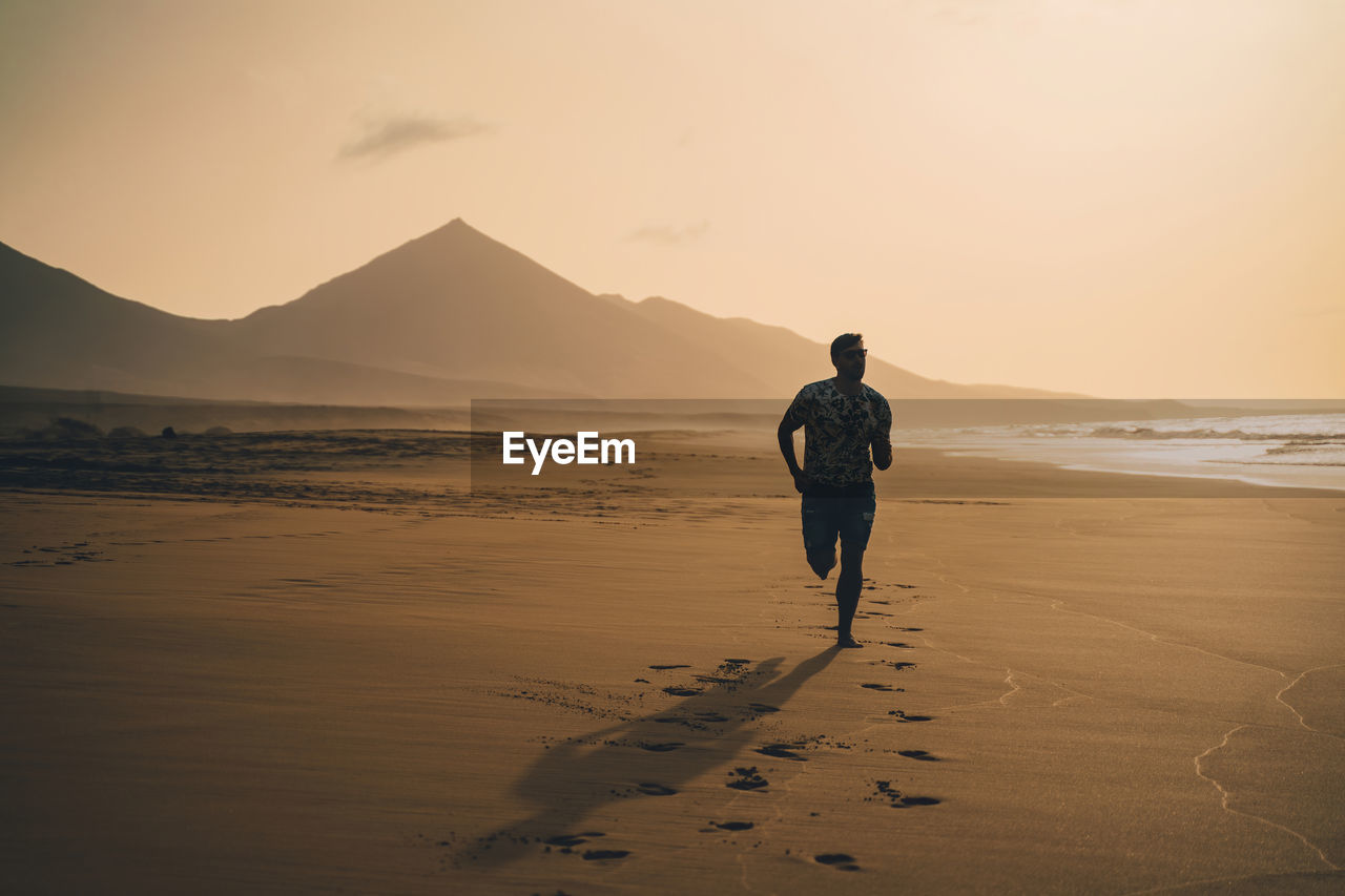 Full length of man running at beach